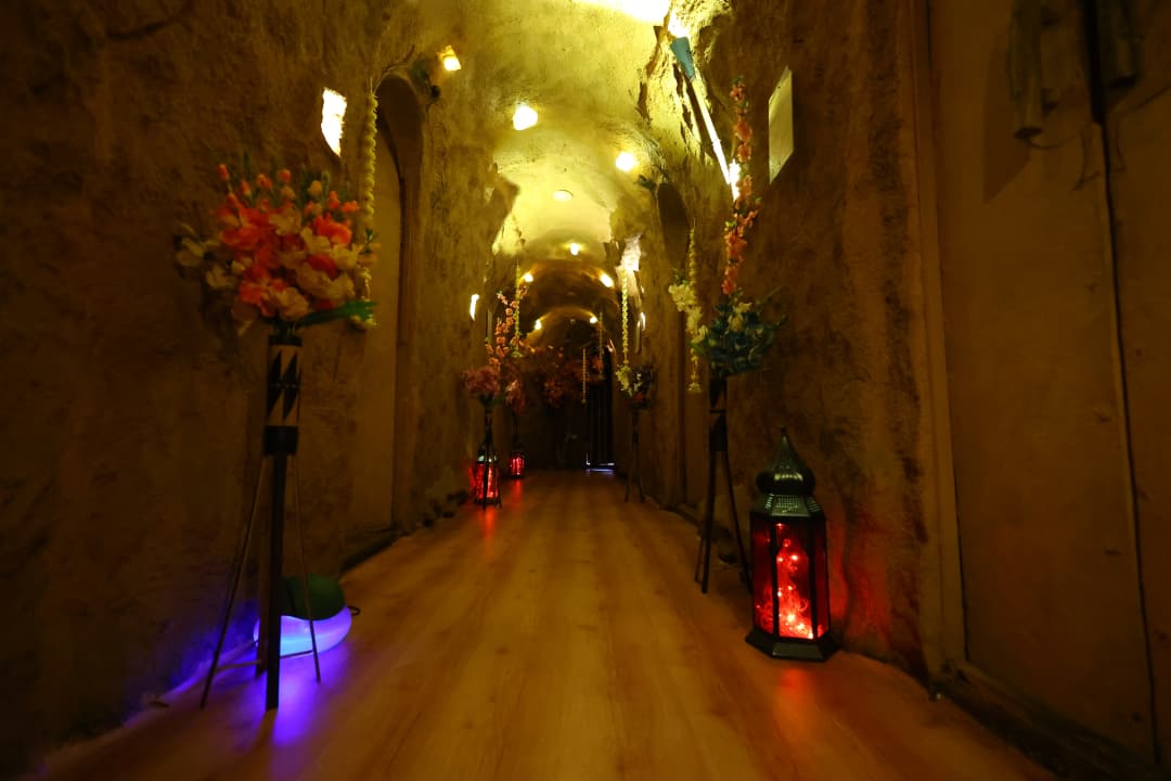 Hall of verosha the cave spa, with a cave experience and a women walking.