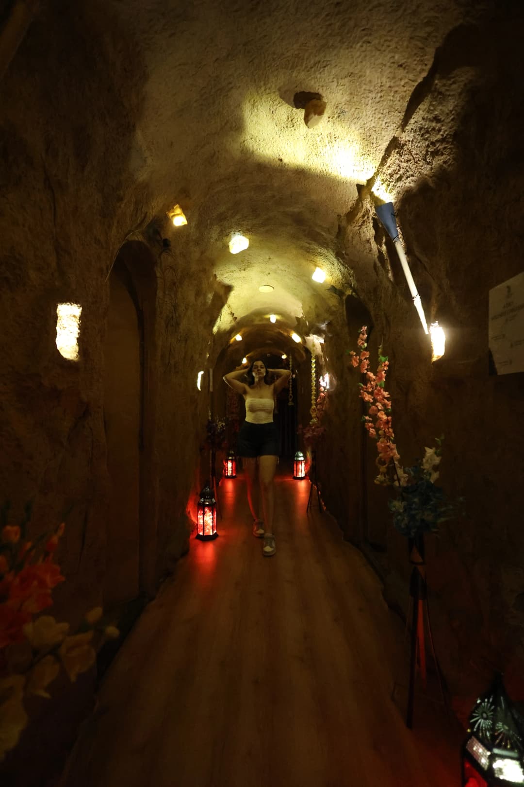 Hall of verosha the cave spa, with a cave experience and a women walking.